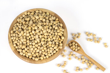 Soybean on wooden spoon and wooden bowl isolated on white  background top view.