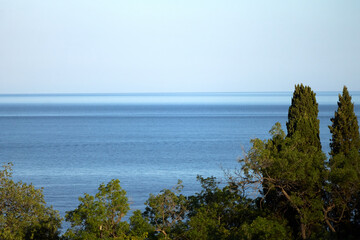 Beautiful boundless sea with green plants on the mountain. Incredible nature, breathtaking views of the sea and green plants.