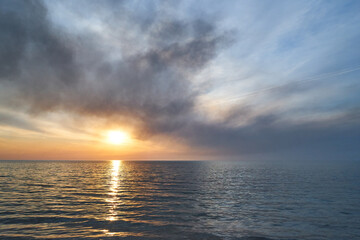 Sea sunset. Smoke wildfires sweeping across the sky.