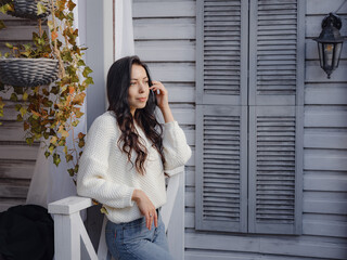 woman spends free time outdoors near house on terrace