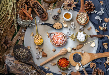 Naklejka na ściany i meble Various spices and herbs in rustic style with honey on balck background. Natural herbs medicine, Organic herbal and healthy concept, Selective focus.