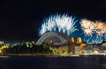 Gartenposter Sydney Harbour Bridge New Years Eve fireworks, colourful fire works lighting the night skies with vivid multi colours © Elias Bitar