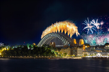 Sydney Harbour Bridge New Years Eve fireworks, colourful fire works lighting the night skies with...