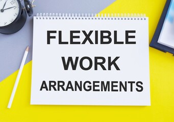 Flexible Work Arrangements. text on white notepad on gray, yellow background, Top view flat lay,...
