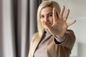 bright picture of young woman making stop gesture