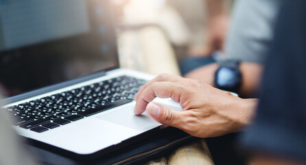 Focus on hand, businessman using computer laptop working outdoor, concept working with new normal and don't have to work in the office.