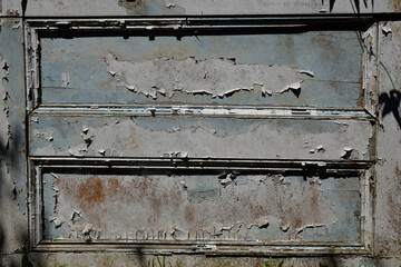 A vintage door with a peeling paint grunge texture