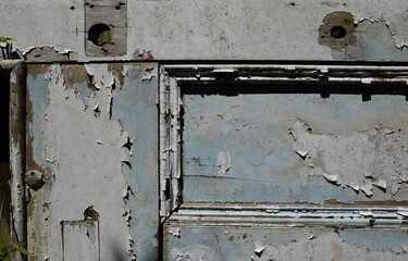 A vintage door with a peeling paint grunge texture
