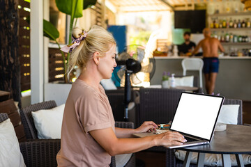 Young woman sitting on sofa at hotel lobby working laptop computer