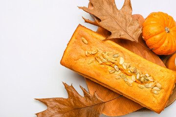 Wooden board with tasty pumpkin pie on white background