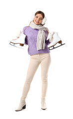 Beautiful young woman in winter clothes and with ice skates on white background