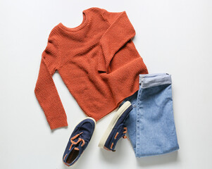 Children's sweater, jeans and shoes on white background
