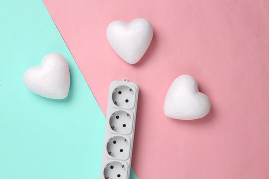 Electrical Extension Cord And Hearts On A Blue-pink Pastel Background. Top View. Flat Lay