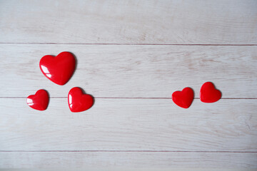 Red Heart symbol composition on white wooden background. Heart decoration photo for Valentine, Mother's day, love concept design. 