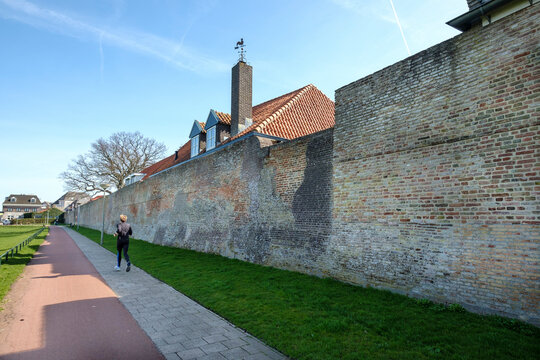 Runner along the city wall of Harderwijk, Gelderland Province, The Netherlands
