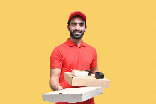 young joyful delivery man in red t shirt holding pizza boxes indain pakistani model