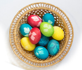 Easter colored eggs in a wicker vase
