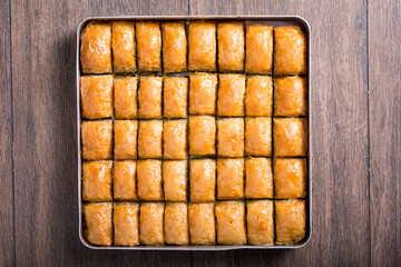 baklava with walnuts in tray
onthe wooden table