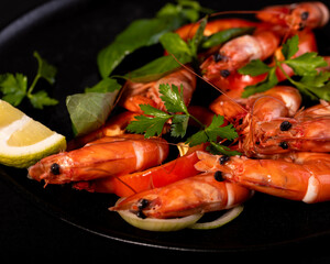 A plate with king prawns served with fresh lemon and parsley leaves