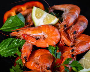 A plate with king prawns served with fresh lemon and parsley leaves