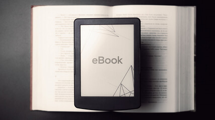 E reader. Digital e book, library reader tablet with books on dark background. Online education course, E learning class and ebook digital technology concept.