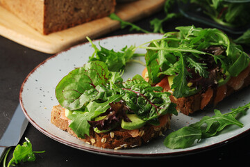 Sandwiches with salmon, avocado and salad