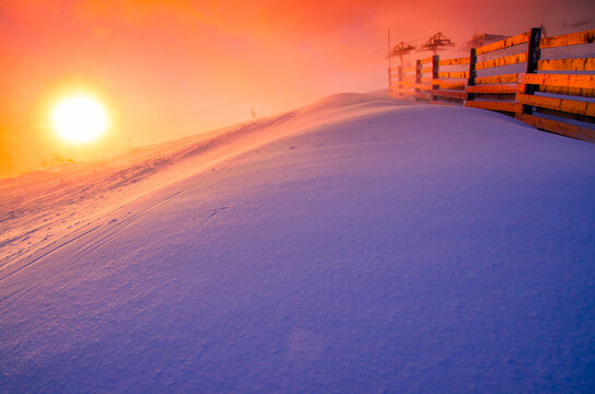 Beautiful warm sunset in ski resort, mountains. Wonderful winter photo, edit space