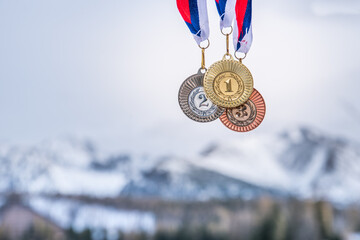 Gold, silver and bronze medal with winter nature in background. Sport trophy concept photo for...