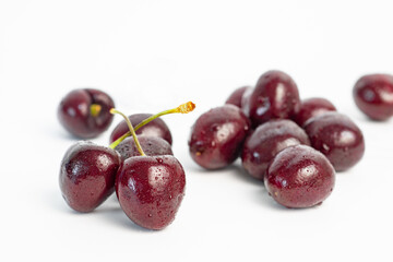 red cherry berries with water droplets  isolated on white background