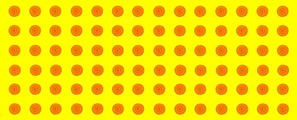 Carrot slices pattern, top view of carrot slices isolated on yellow background.