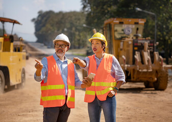 Surveyor builder Engineer technician  Business Team discuss plan at new construction site.