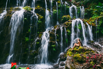 Cascade waterfall with young woman tropical jungle at Bali.