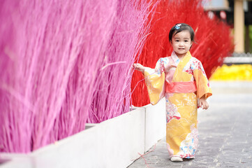 Asian cute little girl in Japanese traditional costume walking and sightseeing with copy space. - Powered by Adobe