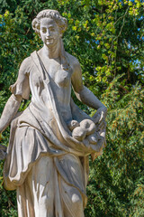 Ancient decayed statue of a sensual Renaissance Era woman in the central city park of Potsdam, a...