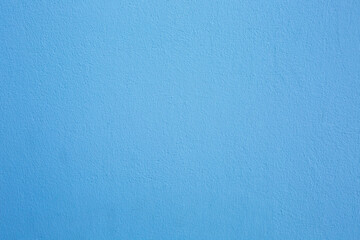 A concrete wall painted blue. Background, texture.
