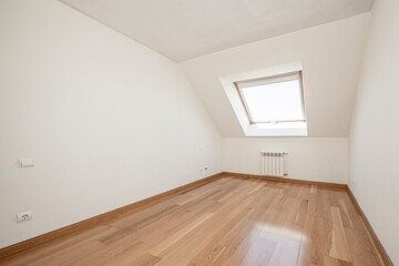 Fototapeta premium Empty room with loft-style ceilings, window and oak parquet floor with aluminum radiator.