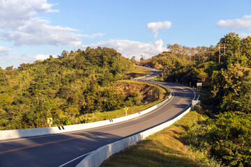 Curve road No. 3, or sky road on Root 1081 over top of mountains with green jungle in Santisuk - Bo Kluea District. Beautiful landscape scenic of road number three at Nan, Thailand.