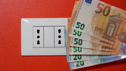 Europe, Italy , Increase in the cost of bill for  gas and electricity causes increased price for the procurement of raw materials, money euro banknote and domestic heating radiator