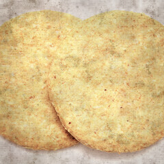 square stylish old textured paper background with round baked oatcakes
