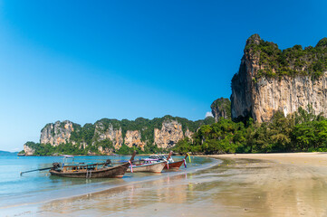 beautiful reflection of natural mountain and Longtail boat on send beach Railay Beach, in Krabi, Ao...