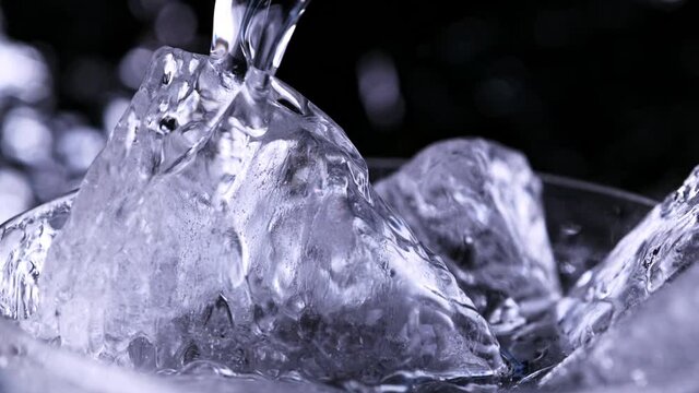 Super Slow Motion Detail Shot of Pouring Vodka on Ice Cubes at 1000 fps.