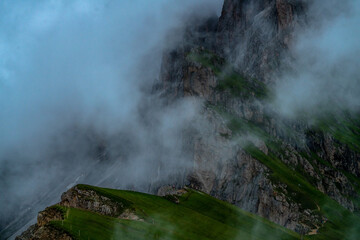 Dolomites Alps. Ortisei. Italy. Panoramic view of mountain Seceda covered with fog.
