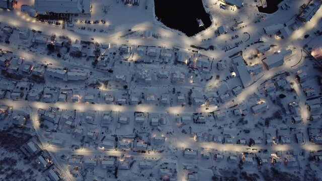 Aerial view of norwegian village at night, top down view 