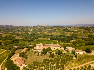 Obraz na płótnie Canvas Aerial/Drone Panorama of Tuscany landscape with vineyards and olive trees - With Montauto castle and San Gimignano - Italy 