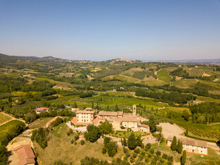 Aerial/Drone Panorama of Tuscany landscape with vineyards and olive trees - With Montauto castle and San Gimignano - Italy	