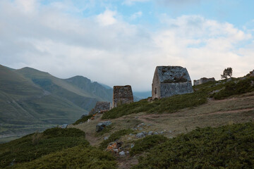 mountain landscape, stone crypts on the mountainside, dolmens, ancient burials, ancestral cemetery