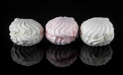 Airy marshmallow dessert marshmallows. Three sweet pieces of marshmallow on a black background. Dessert meringue