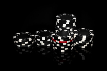 Stack of chips obtained as a result of winning on the black table. Successful casino poker game