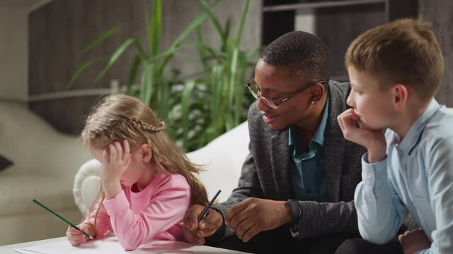 African-American man educator in glasses asks question to student and girl becomes offended at private English tuition with native speaker at home slow motion
