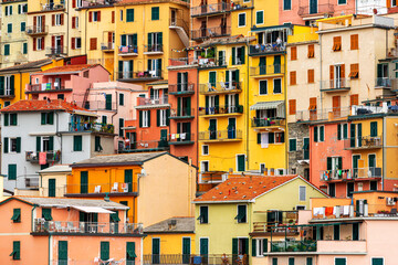 colorful house, buildings and old facade with windows in small picturesque village Manarola Cinque...